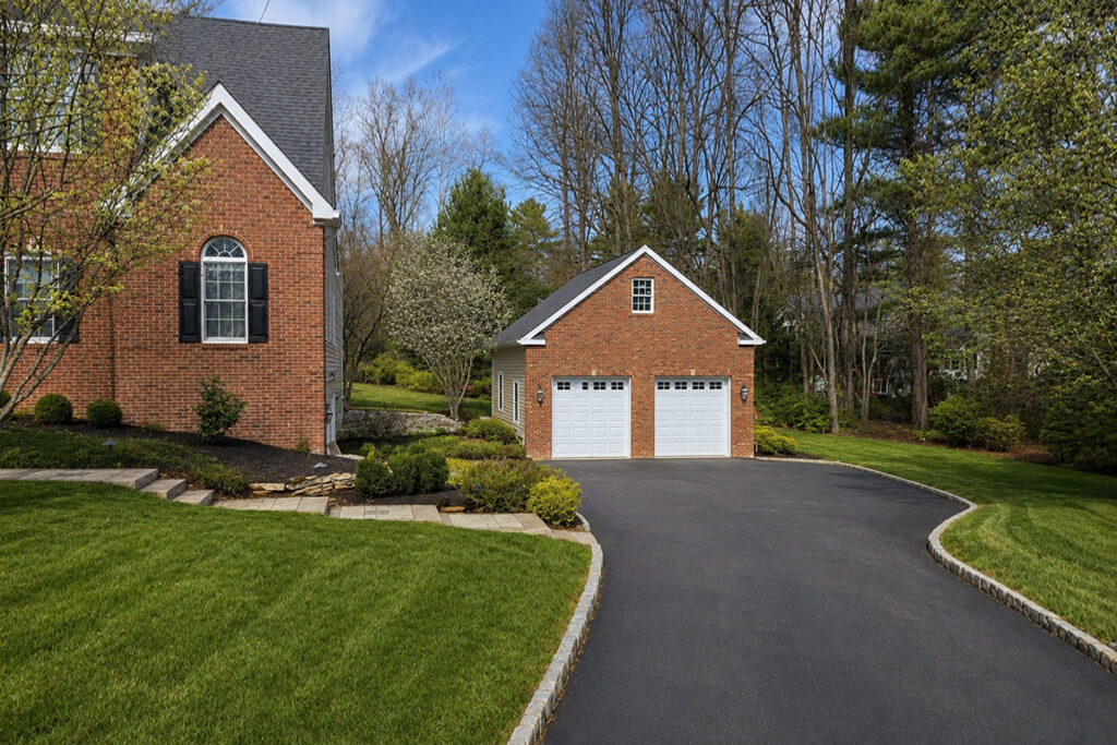 New construction high-end garage with 12 foot ceilings and brick front in Colts Neck, NJ Red brick front new luxury garage build in Colts Neck NJ features 2 garage doors, tons of attic space and 12 foot ceilings. Wifi security cameras and high tech heating and cooling system.
